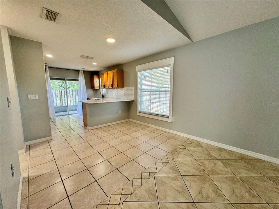 KITCHEN LEADS TO FENCED IN BACKYARD.