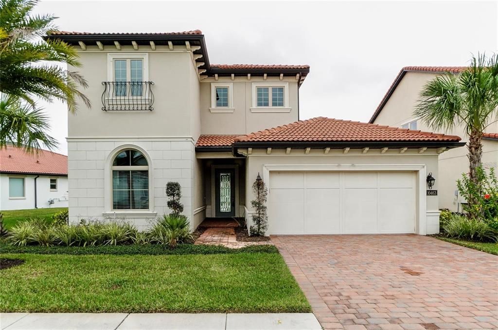 paved driveway with fully maintained lawn