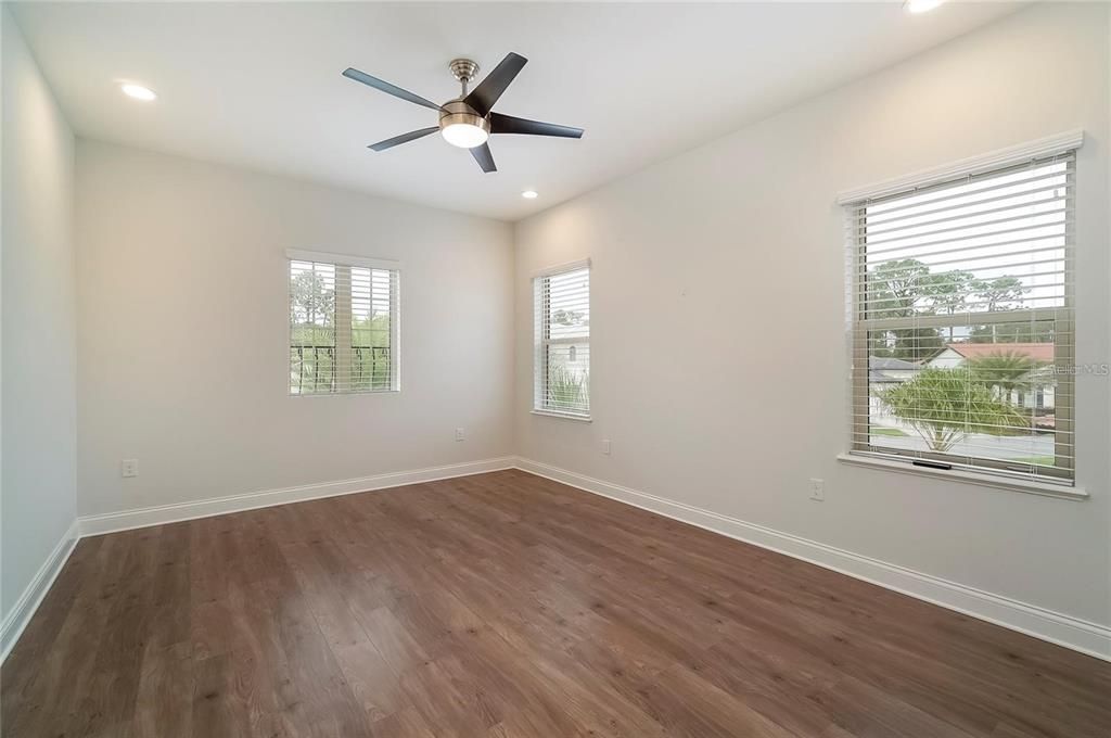 bedroom with ceiling fans and vinyl floors