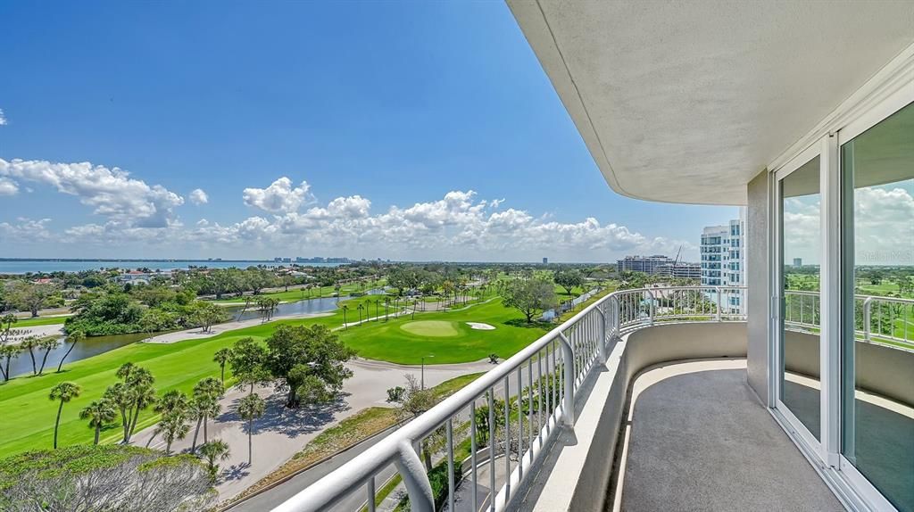 Sarasota Bay and Longboat Key Club golf course from the wraparound balcony, with downtown SRQ skyline in the distance.