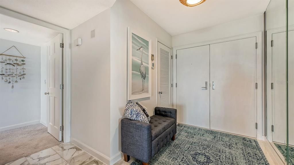 Double-door entry and foyer (utility closet not pictured includes large stackable washer/dryer).