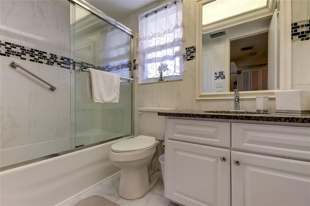 guest bath, tub with shower doors