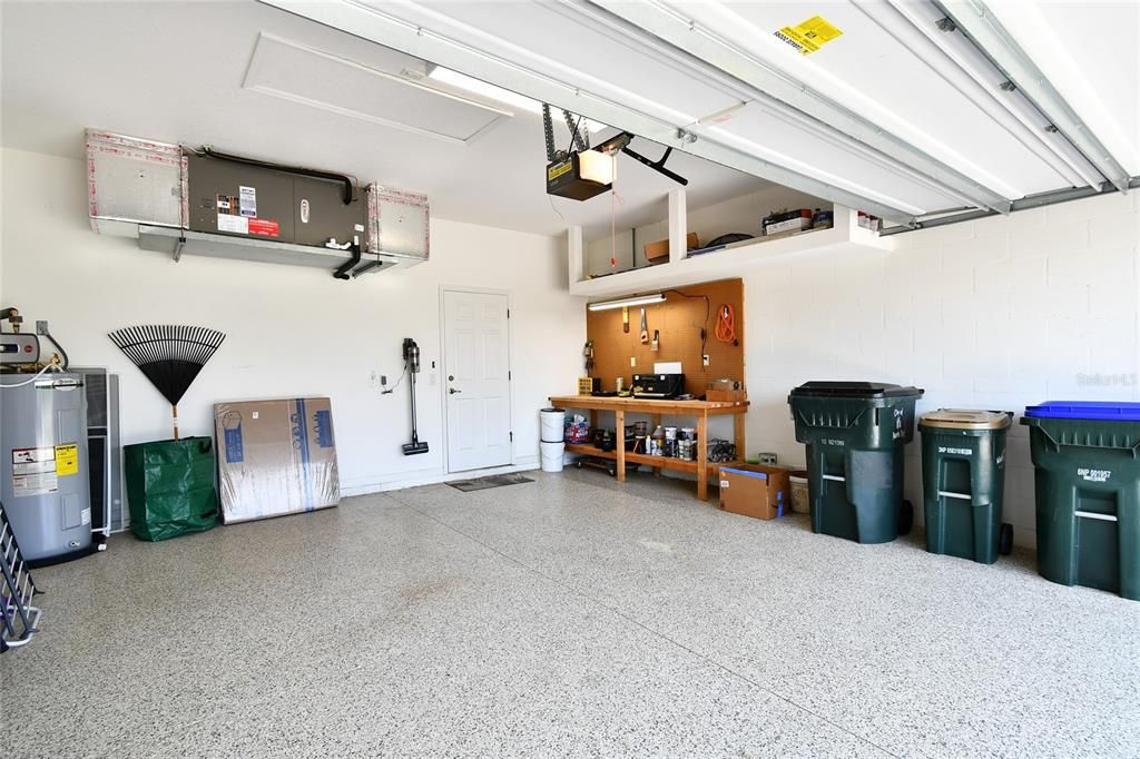 Two-car garage with Expoxy flooring and workbench.
