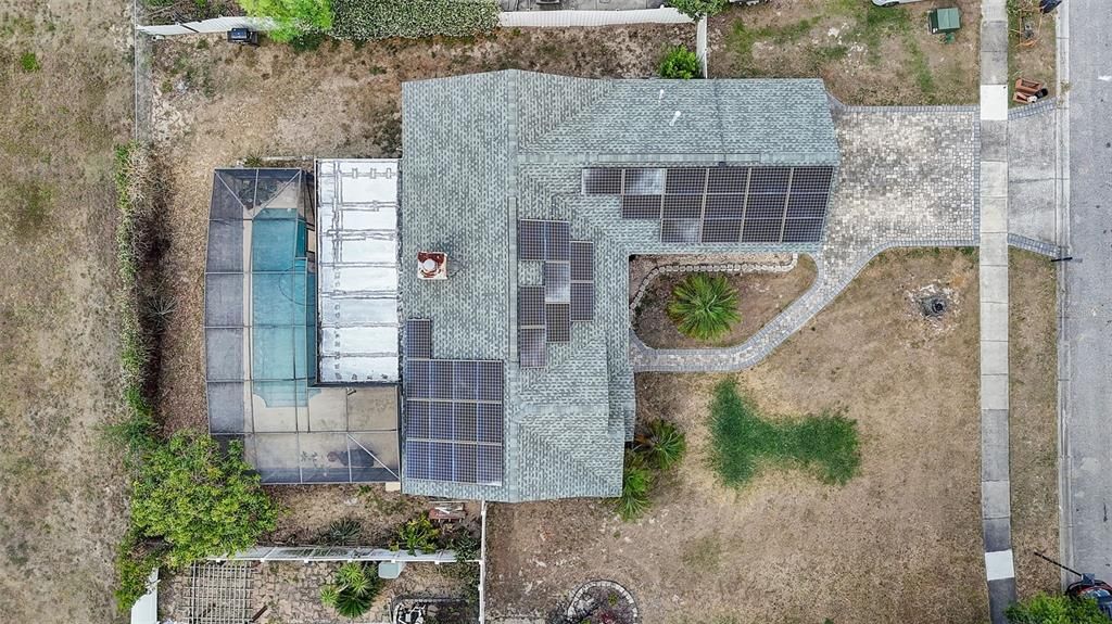 36 ROOF MOUNTED TESLA SOLAR PANELS installed in 2019 COST THE OWNER approximately $34,000.00 at the time. The TESLA SOLAR SYSTEM IS PAID OFF and the NEW OWNER will REAP ALL THE BENEFITS. The TOP-OF-THE-LINE TESLA PHOTOVOLTAIC SYSTEM has ELIMINATED THE ENTIRE POWER BILL, with the exception of the small monthly service charge the power company charges. ALL OF THE MAJOR MECHANICALS ARE ALSO UPDATED! The ROOF was installed in July of 2022, the AC system was installed in June of 2023, the GAS WATER HEATER was installed in October of 2022, the KITCHEN was RENOVATED with NEW CABINETS, REFINISHED COUNTERTOPS, and BRAND-NEW STAINLESS-STEEL APPLIANCES INCLUDING A GAS RANGE for your CLEAN COOKING NEEDS!! The POOL and SCREEN ENCLOSURE WERE ALSO ADDED in 2006!