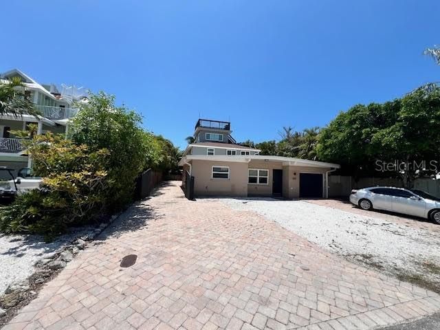 View of Front Garage unit for Downstairs 2/2 , Side entry to Private Back Yard and Outdoor Shower.