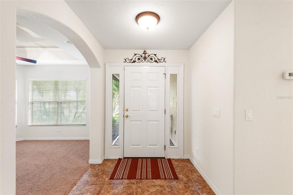 VIEW OF FRONT DOOR & LIVING ROOM TO THE LEFT