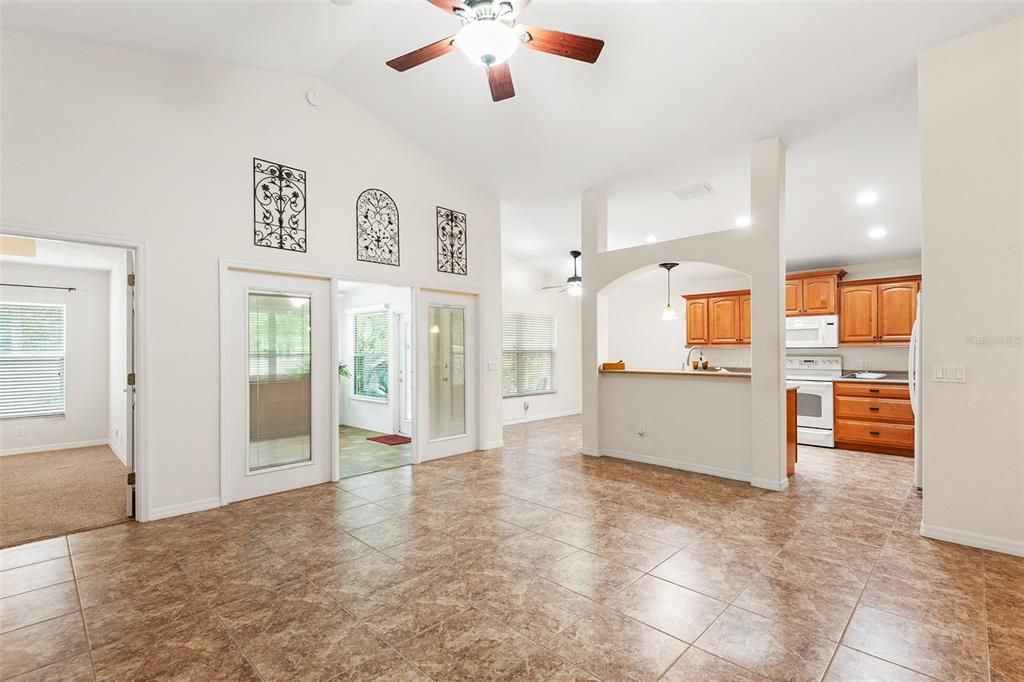 FAMILY ROOM WITH VIEW TOWARDS BONUS/FLORIDA ROOM, DINETTE AREA & KITCHEN