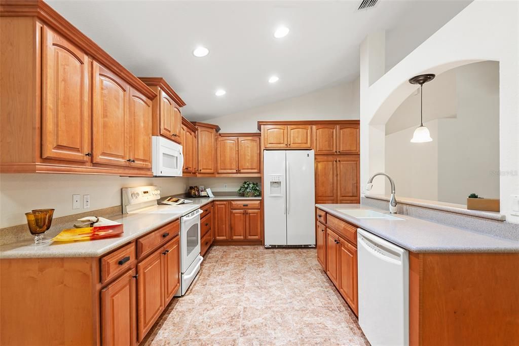 KITCHEN WITH UPGRADED DIAMOND WOOD CABINETRY , CROWN MOLDING AND MANY FEATURES SUCH AS LOWER CABINET & PANTRY PULLOUTS & CORNER CAROUSELS