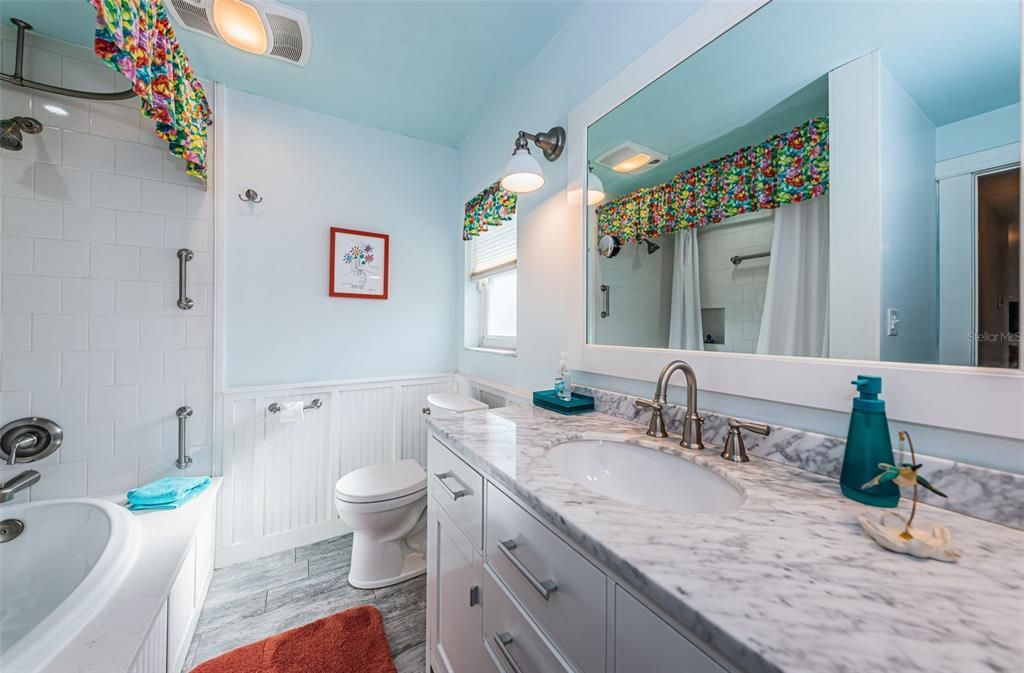 The second bathroom, where simplicity meets comfort! With its handy sink and a shower in a tub, this space offers everything you need for a refreshing wash.