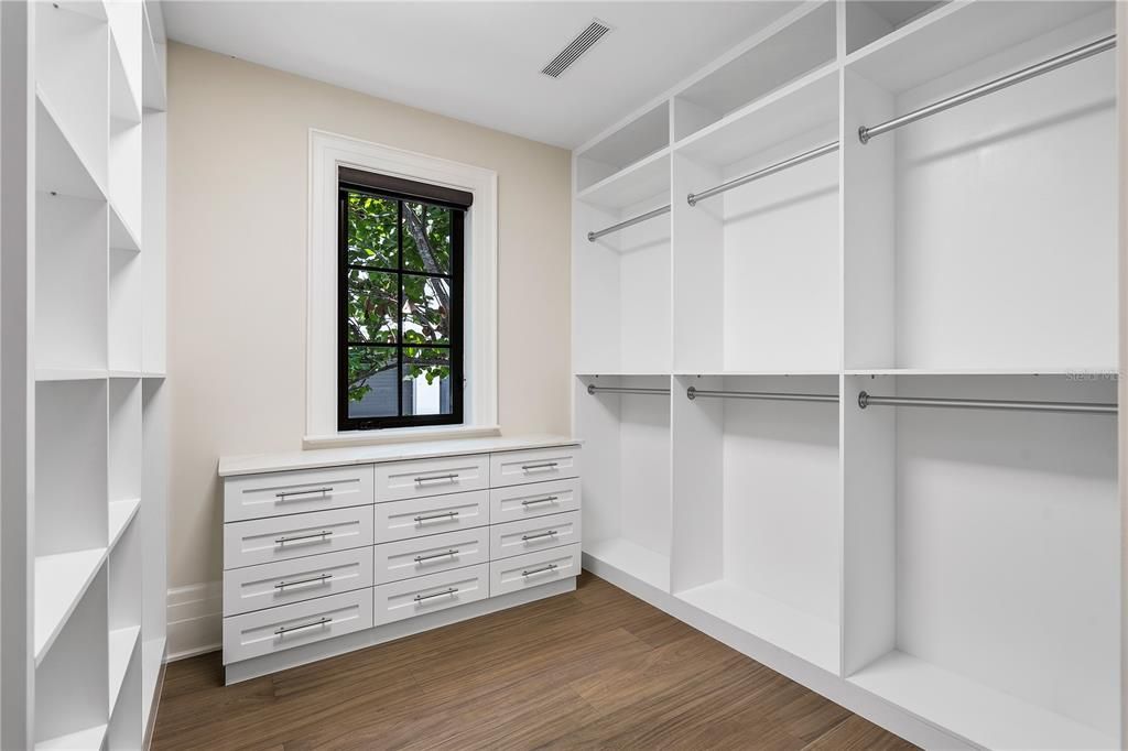 Two custom-fitted walk-in closets, offering unparalleled elegance and organization.