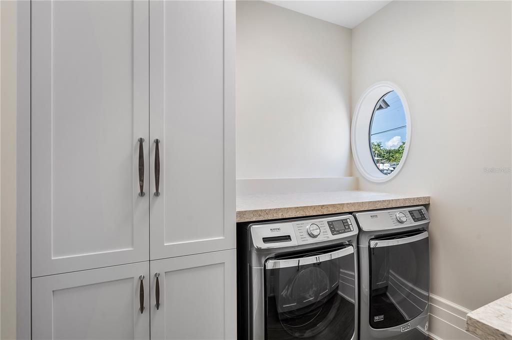 First-floor laundry room, seamlessly integrated for effortless living, complete with a closet for discreet organization