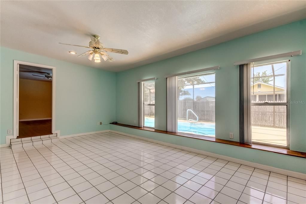 Family Room With View Of Pool; Door Leads To Primary Bedroom.