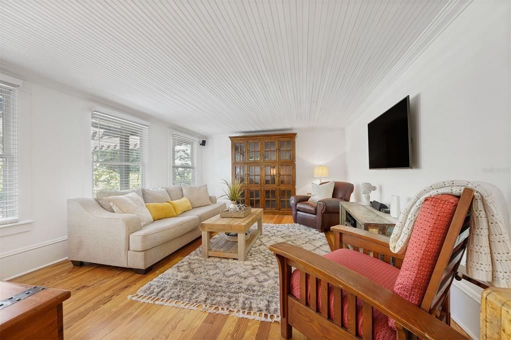 Family Room overlooks backyard with beadboard ceiling