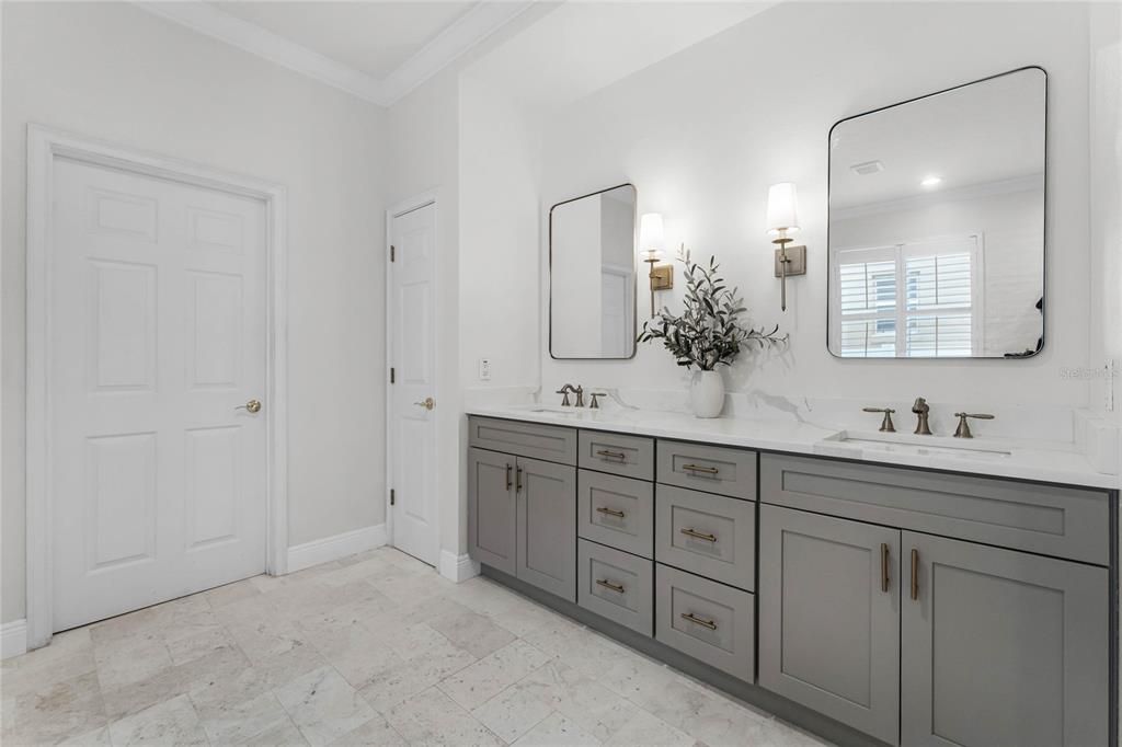 Primary bath with double vanity and framed mirrors