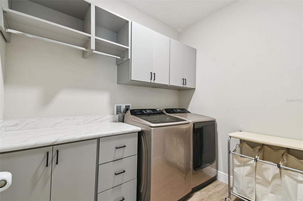 Laundry Room with cabinets and folding table.
