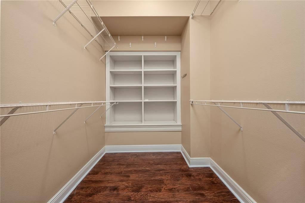 Walk in closet with built ins in owners suite.