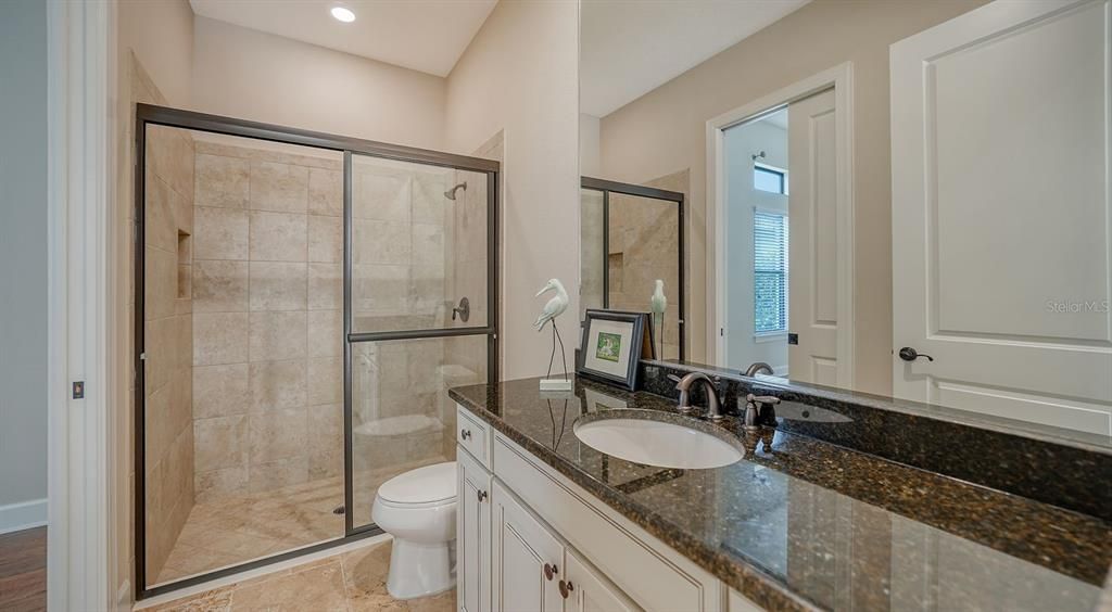 First ensuite bathroom with shower and double size vanity.  Serves as a "pool" bath as well.