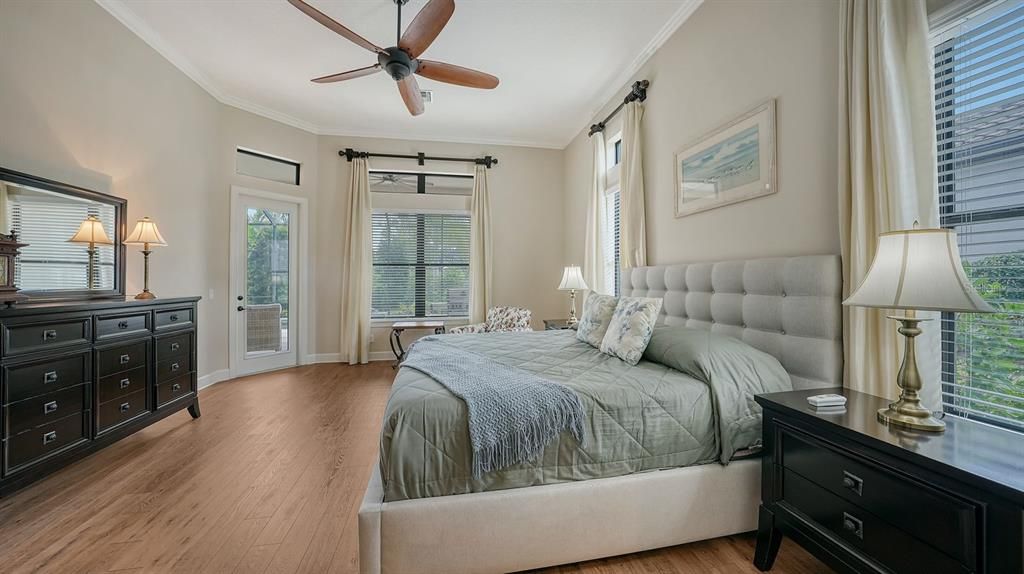 Primary bedroom with engineered wood flooring. door to the lanai