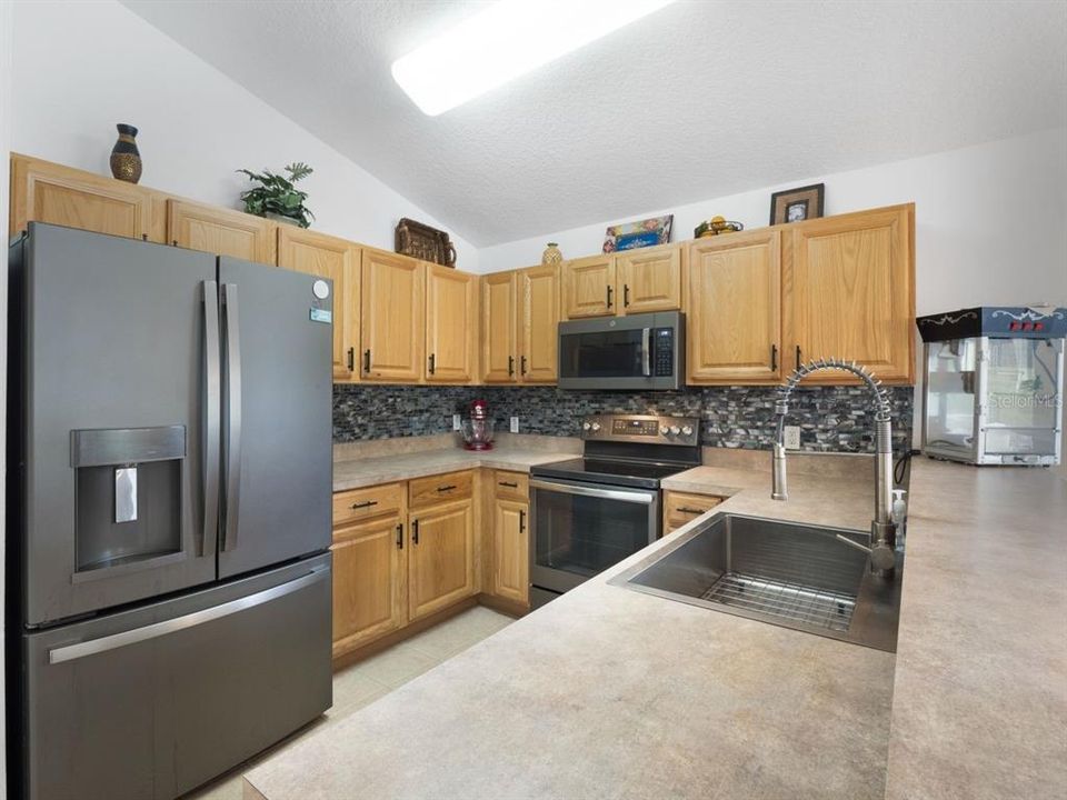 large kitchen equipped with newer slate appliances