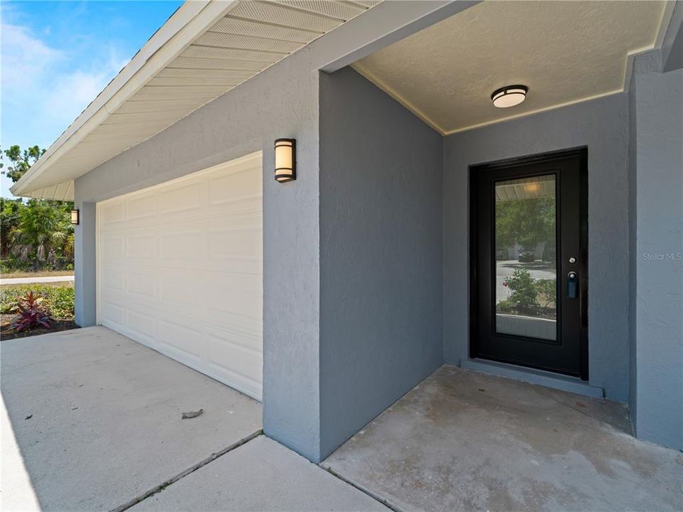 Front entrance with new front door and light fixtures.