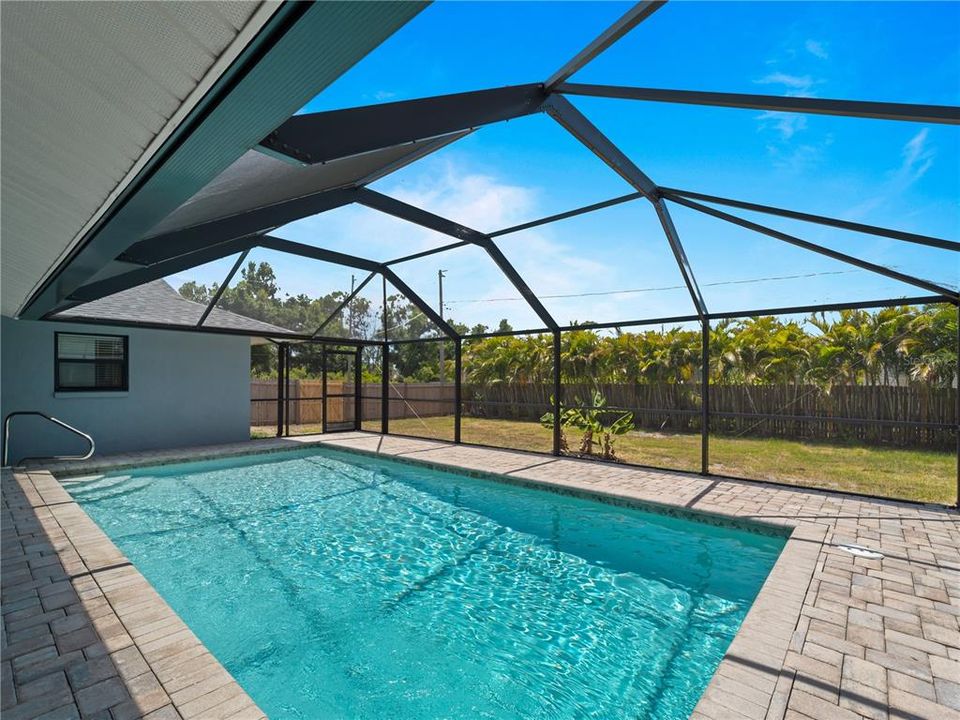 View of the large 14' x 28'  heated swimming pool and fenced backyard.