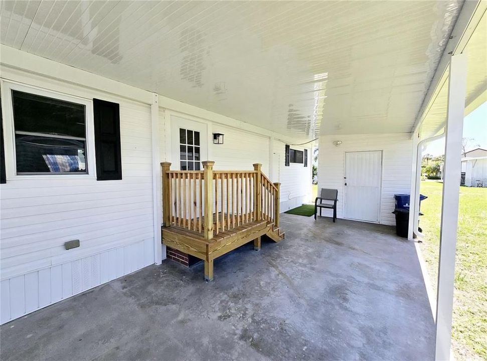 Carport and front entry way, stairs leading up to door