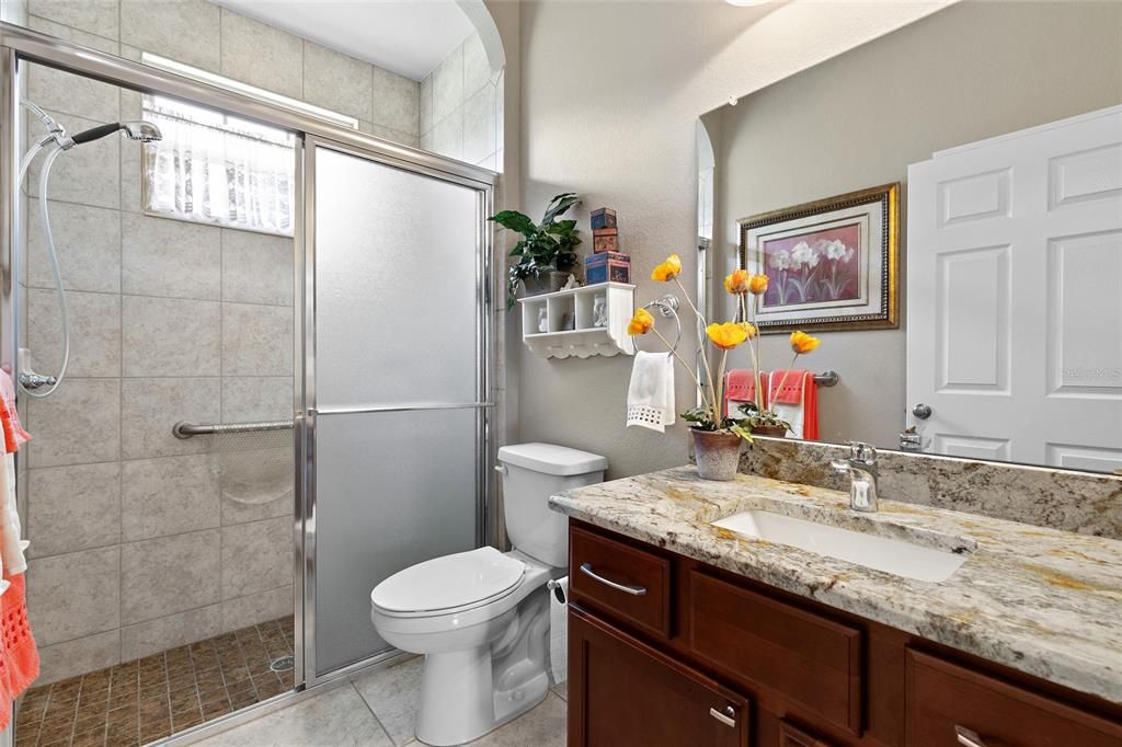 Guest bath with granite counter top, linen closet, large walk-in closet.