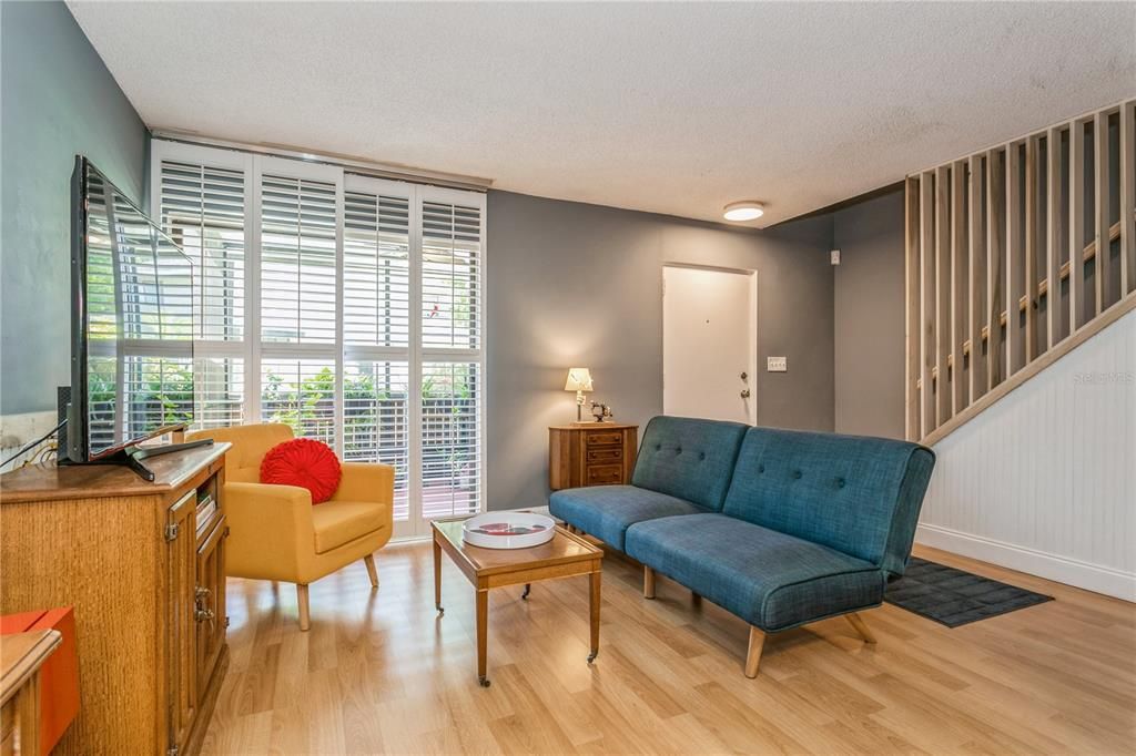 Living Room — Plantation Door coverings with view of Newer banister & Handrail