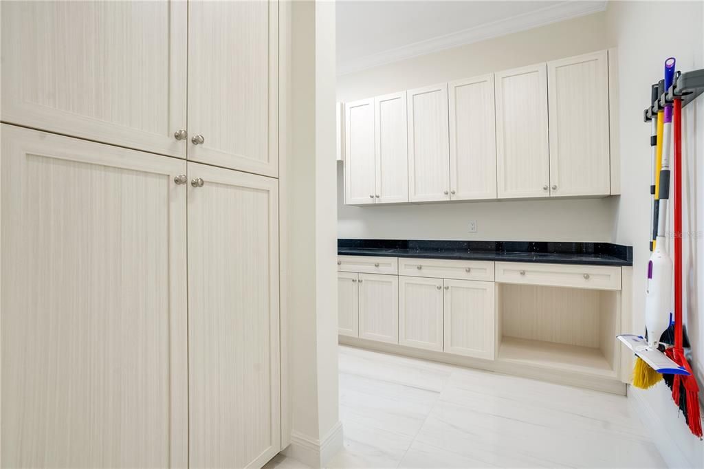 Many cabinets and broom closet