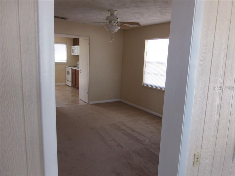 View from front entry to room into Living area