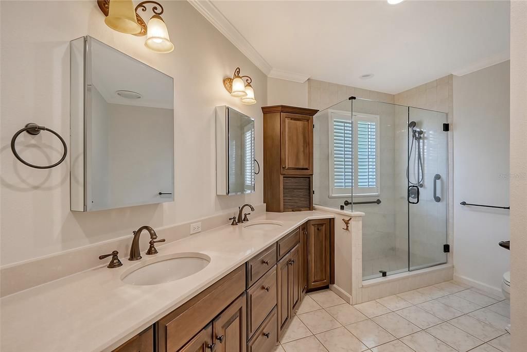primary bathroom with 2 sinks and walk-in shower