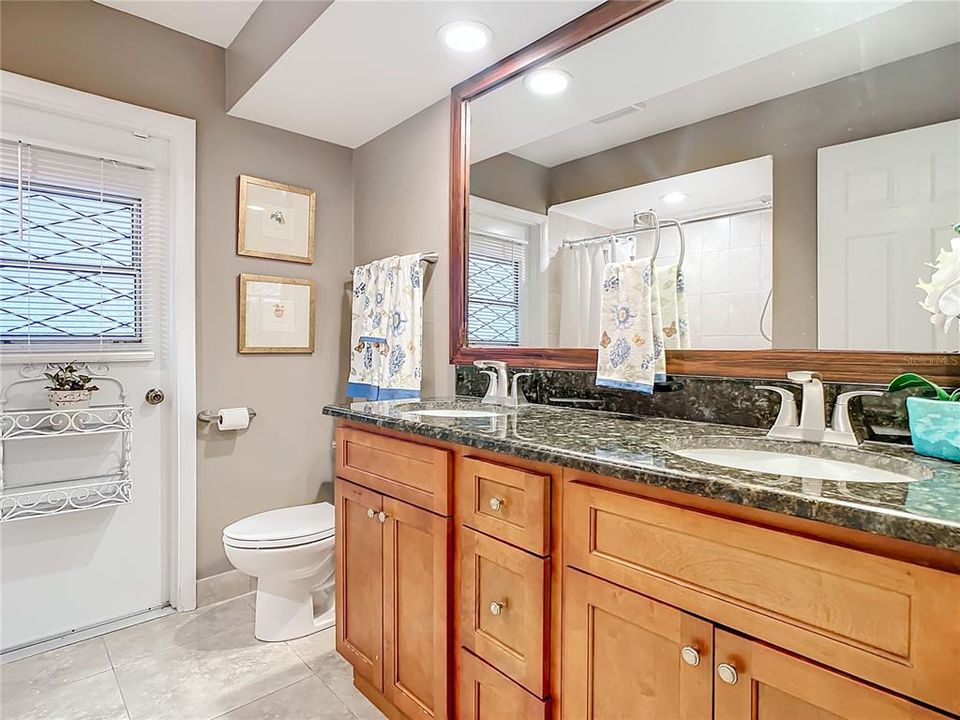 Hall Bathroom with Wheelchair Accessible Doorway.  Door leads to Screen Room and Pool