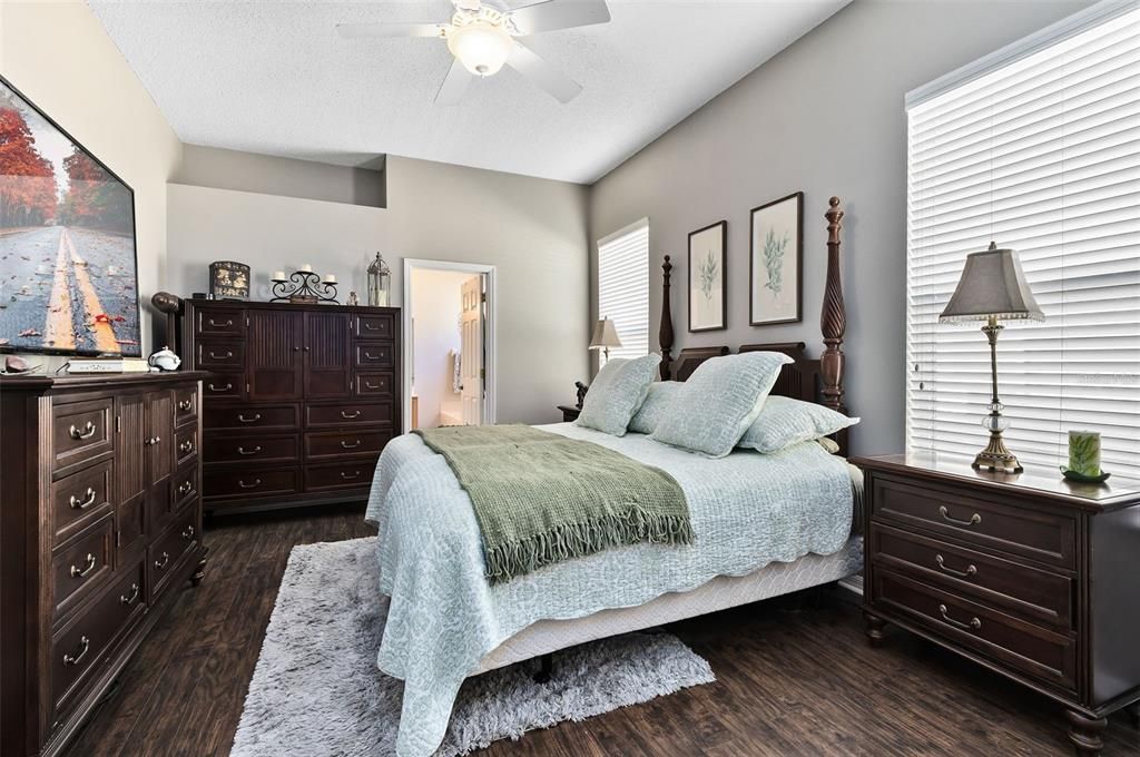 Primary bedroom. Don't miss those gorgeous laminate wood floors!