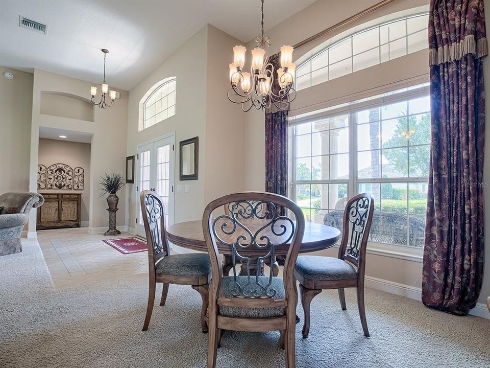 FORMAL DINING ROOM TO THE LEFT OF THE FOYER. CUSTOM DRAPES THROUGHOUT.