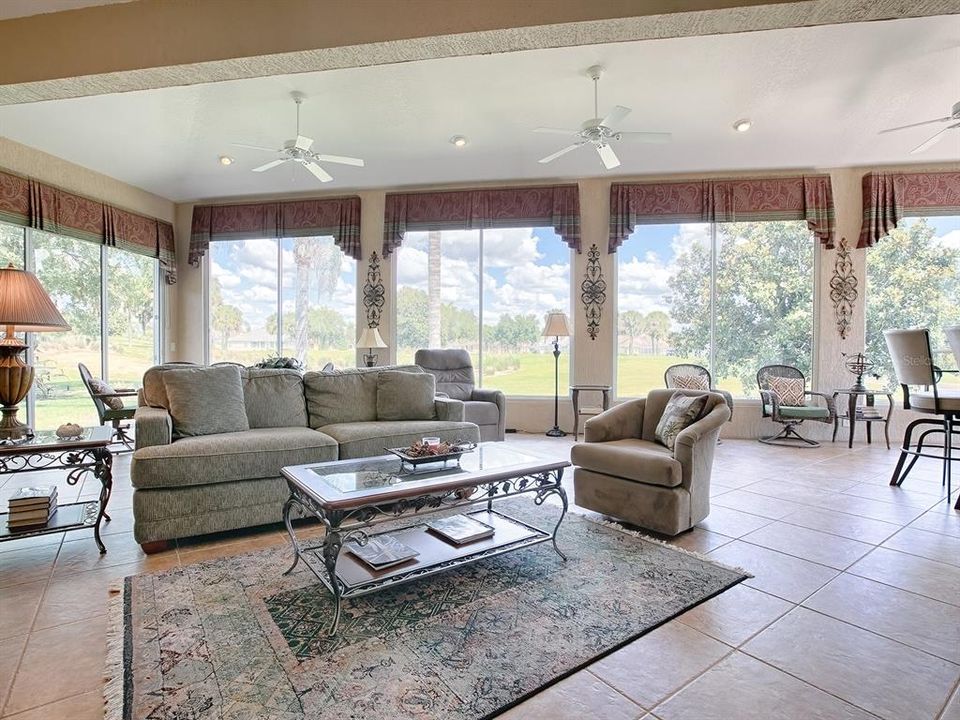 GLASS ENCLOSED FLORIDA ROOM WITH AMAZING GOLF COURSE VIEW. LARGE TILE THROUGHOUT THE ENTIRE ROOM AND 5 CEILING FANS.