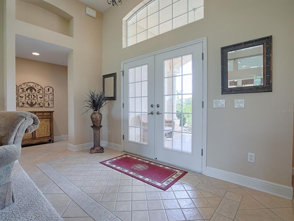 LARGE DIAGONAL TILE IN THE FOYER WITH CUSTOM DESIGNED INSET.