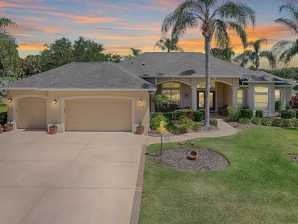 NICE CURB APPEAL WITH PAINTED DRIVE, WALKWAY AND PORCH WITH LOVELY PALMS AROUND THE HOME.