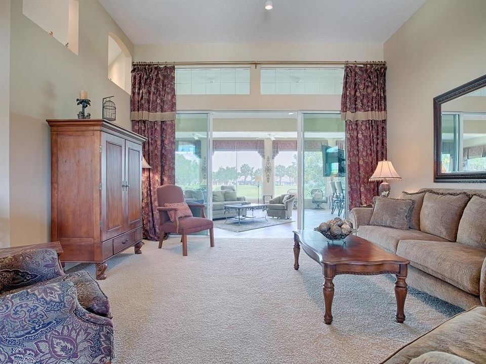 SLIDING GLASS DOORS OPEN OUT TO THE FLORIDA ROOM FROM THE LIVING AREA.