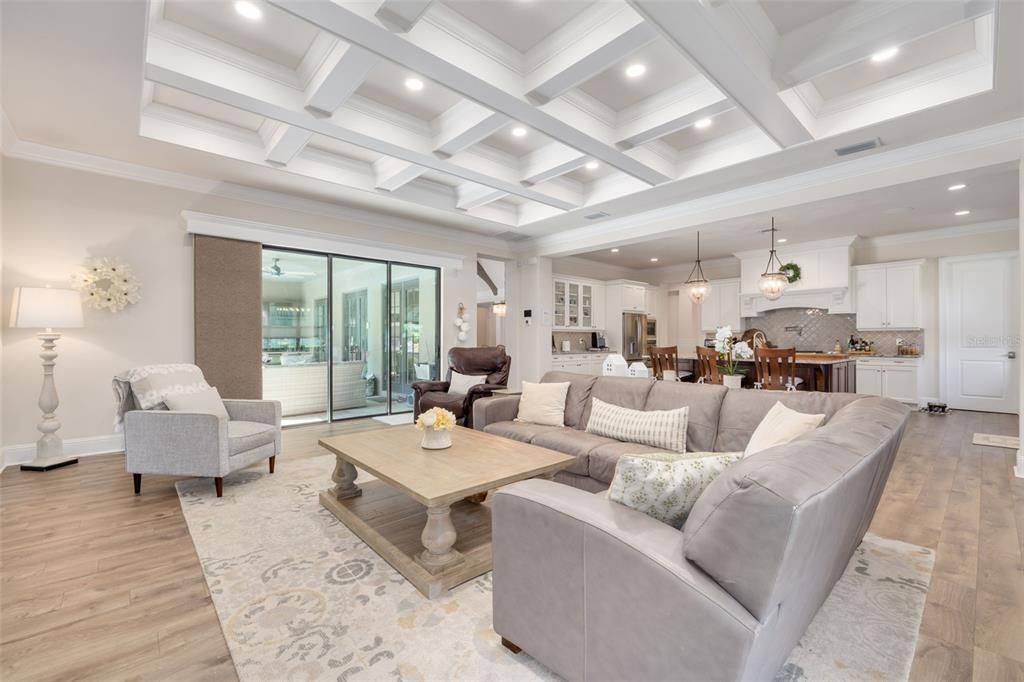 Deep set coffered ceilings.  Family room looking out to large covered lanai