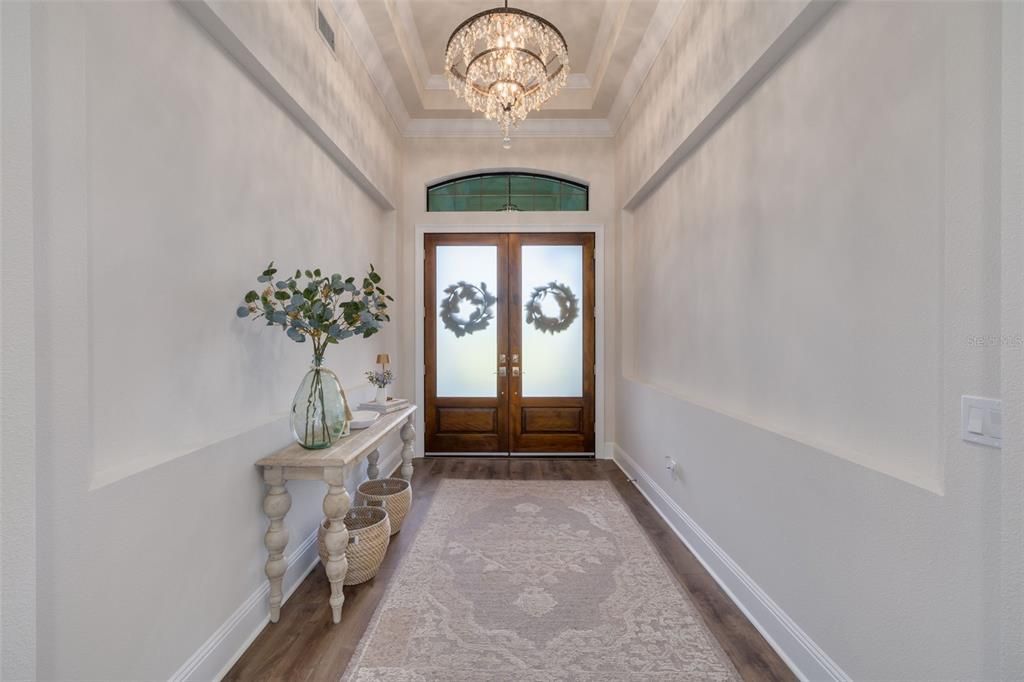 Entry hall with wood vaulted ceiling and art niches