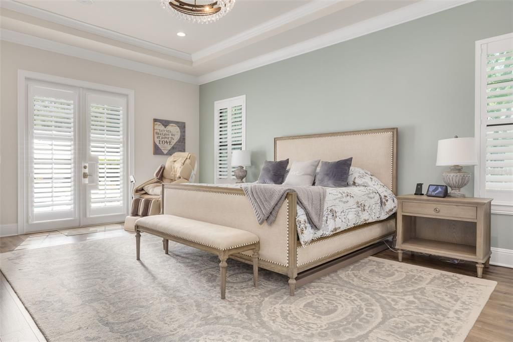 Main bedroom with french doors, coffered ceiling