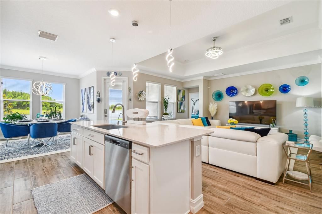 Gourmet kitchen complete with Quartz countertops, SS Appliances, cabinetry with satin finished hardware.