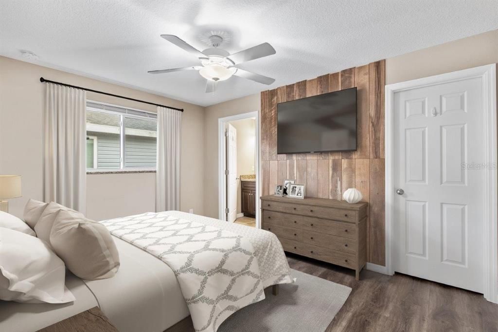 Owners Suite featuring a walk-in closet and ensuite bathroom. *Photo of 3857 Almond Ave, Sarasota, FL 34234*