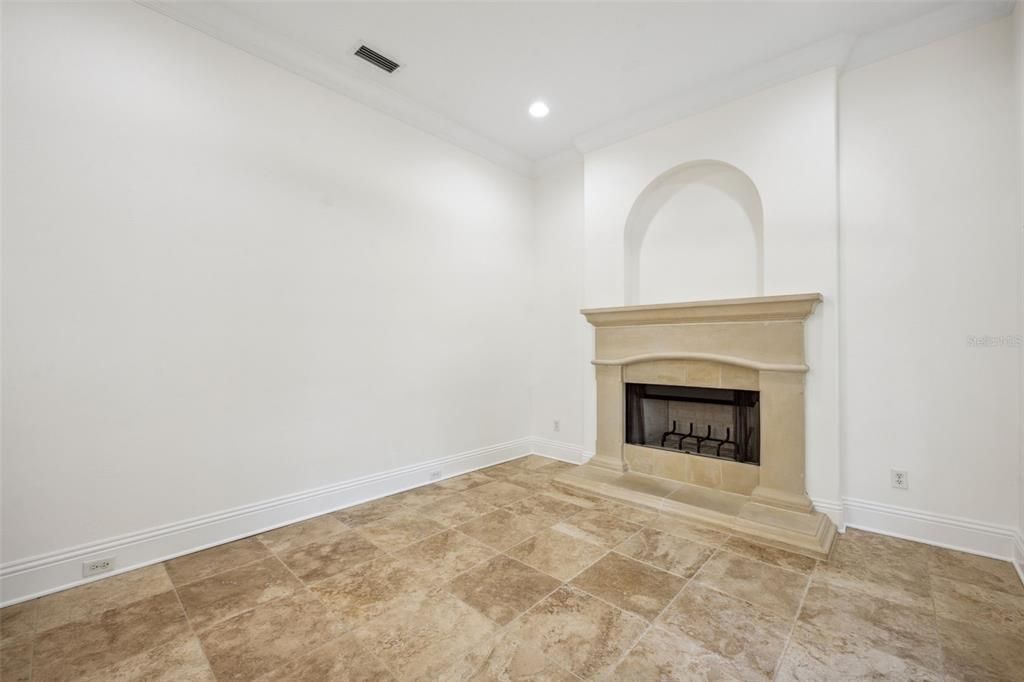 Separate living room features gas fireplace with beautiful stone hearth