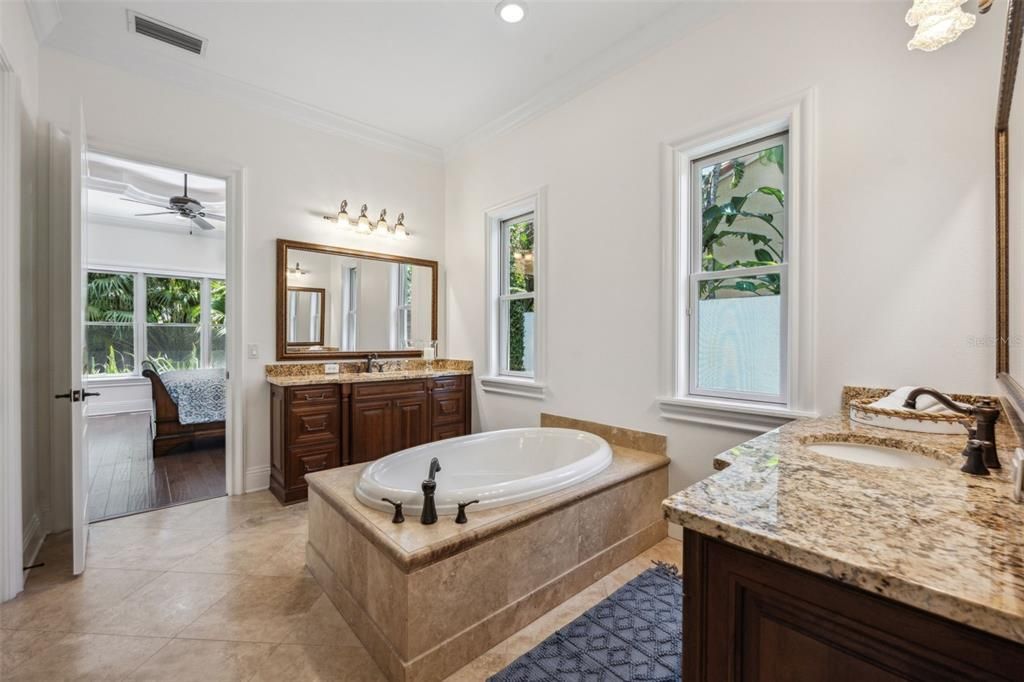 Primary bath with two vanities, rainfall shower plus soaking tub