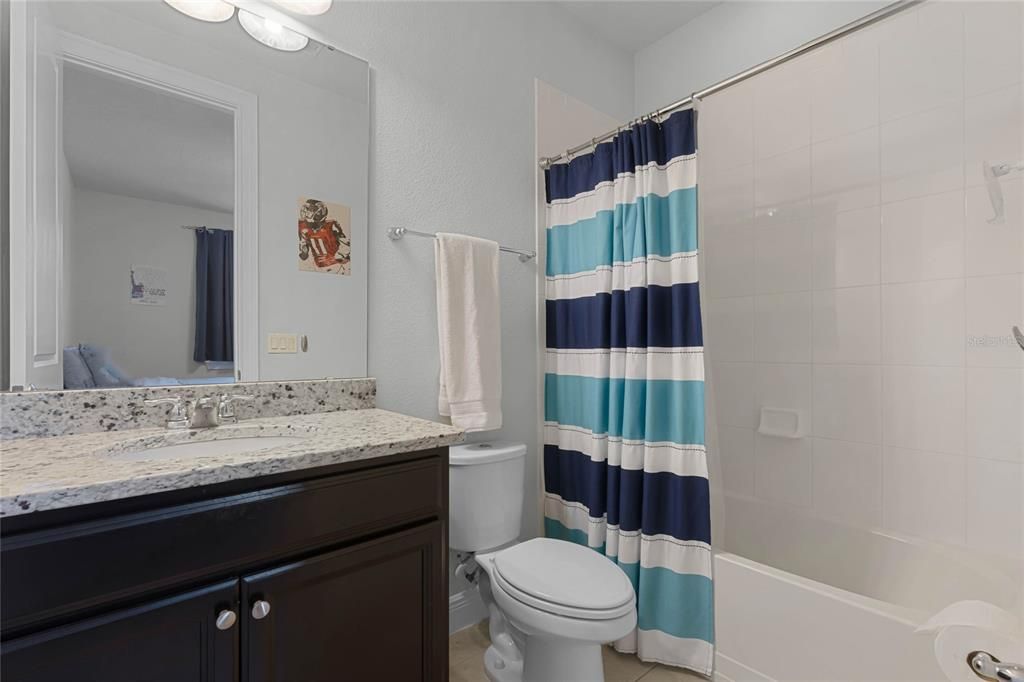 another bathroom with granite countertop