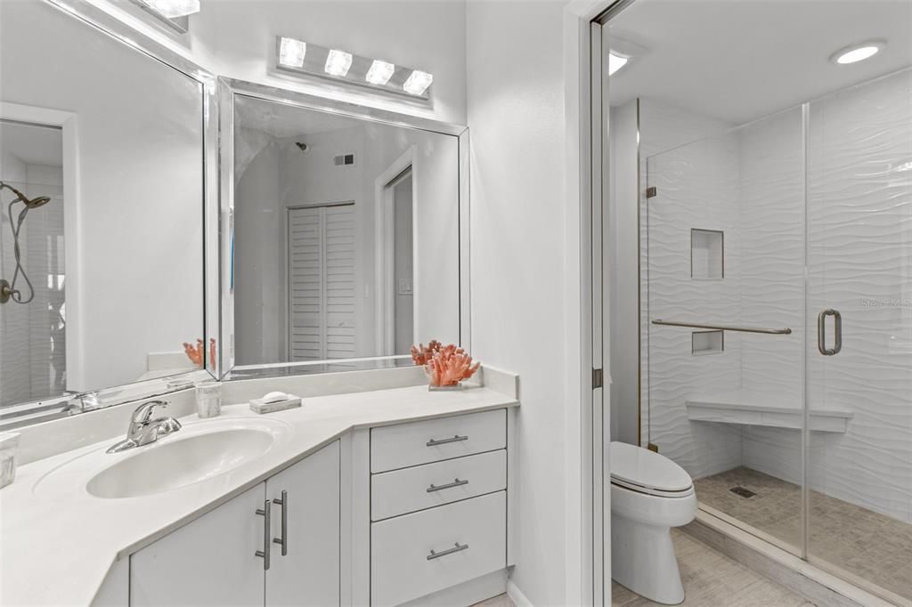Immerse yourself in coastal elegance within the newly renovated ensuite bathroom featuring the ambiance of seaside living.