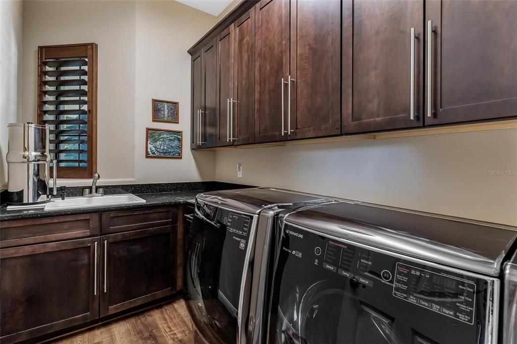 Inside Laundry Room with Lots of Custom Cabinetry and Sink!