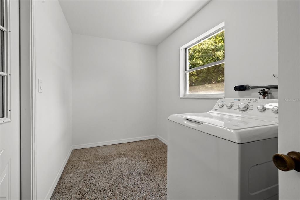 Inside laundry room with storage space.