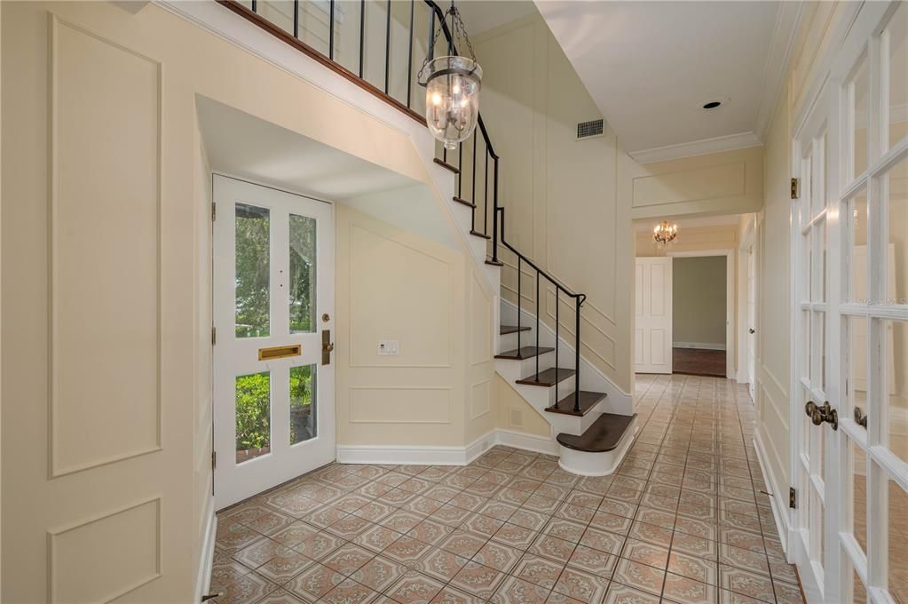 Beautiful tiled Entry and Hallway goes across front of home. French doors open onto it from Dining Rm, Living Rm and Bonus Room